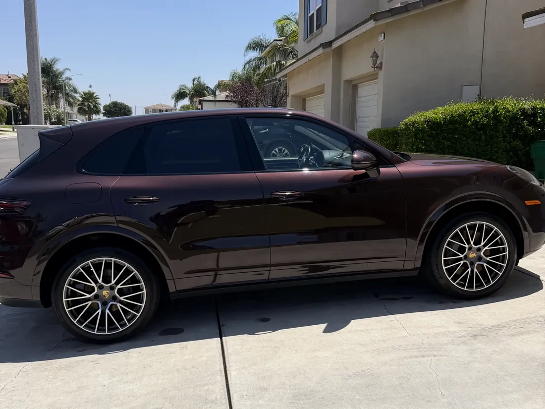 Burgundy Porsche Cayenne with a ceramic coated finish on a residential driveway