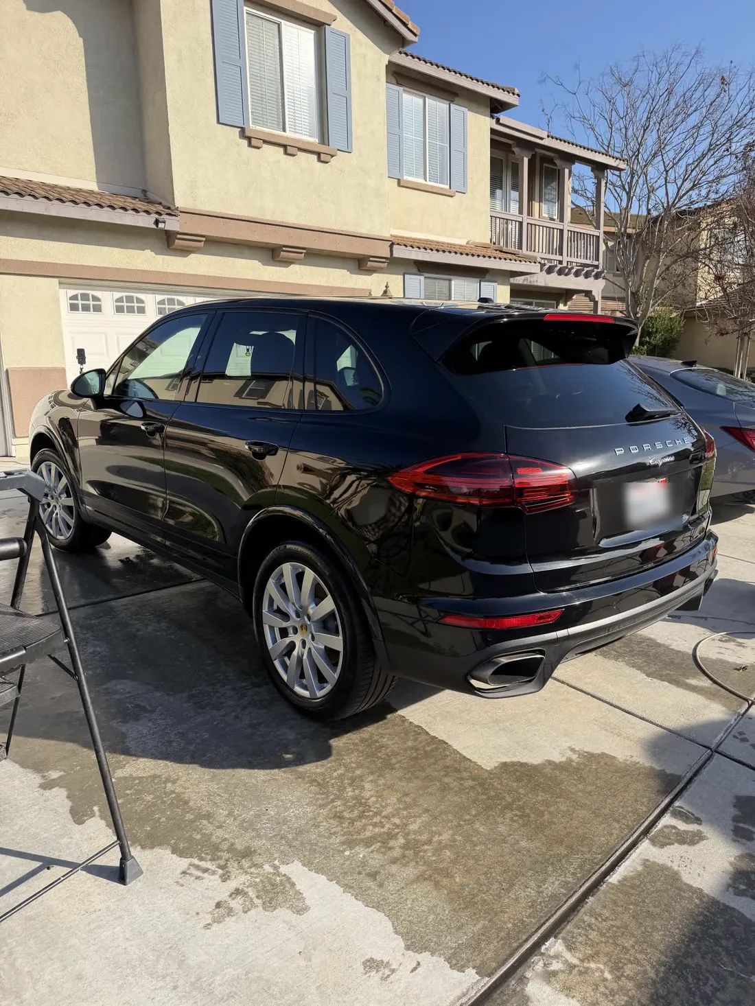 Black Porsche Cayenne showing the depth a ceramic coating leaves in dark paint