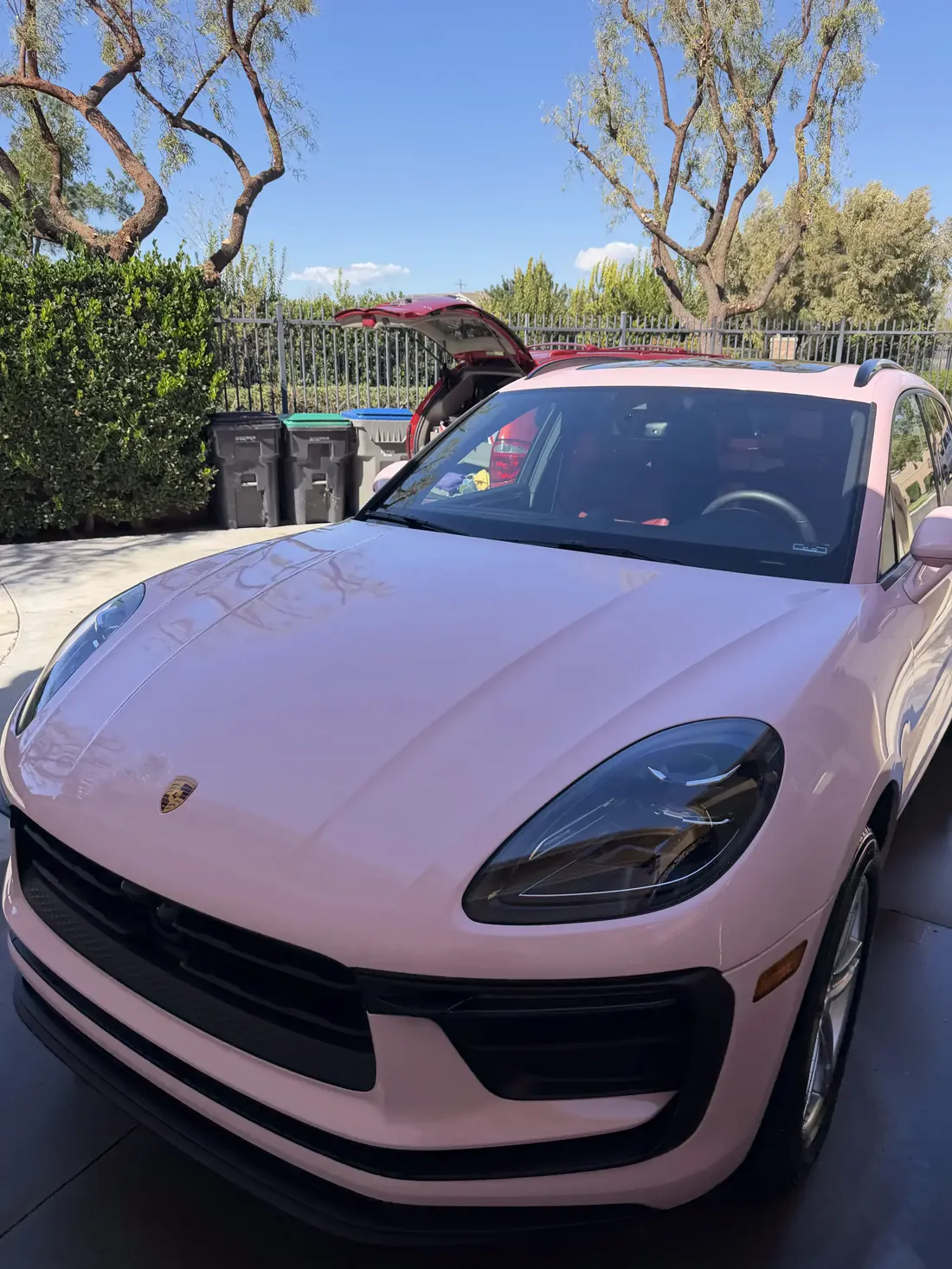 Pink Porsche Macan reflecting the sky after being coated